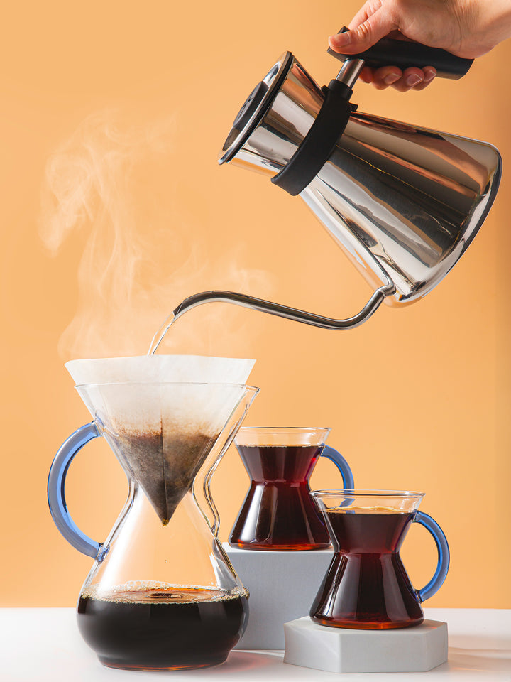 chettle pouring hot water to brew coffee