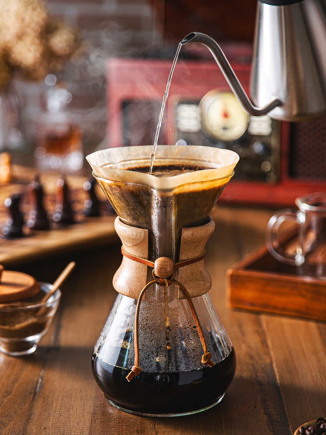 Chettle brewing into the Chemex classic 8-cup, cheese set and record player in the background