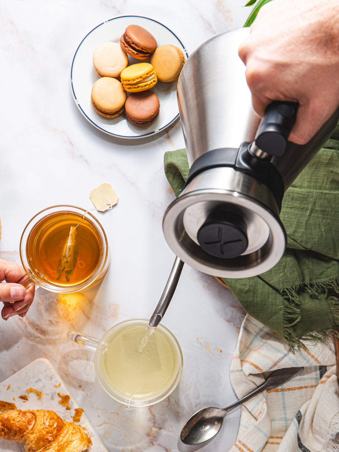 Looking down on the Chettle brewing tea on a marble countertop with pastries