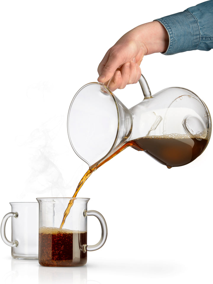The ChemAer coffeemaker pouring coffee into  a Murray Mug