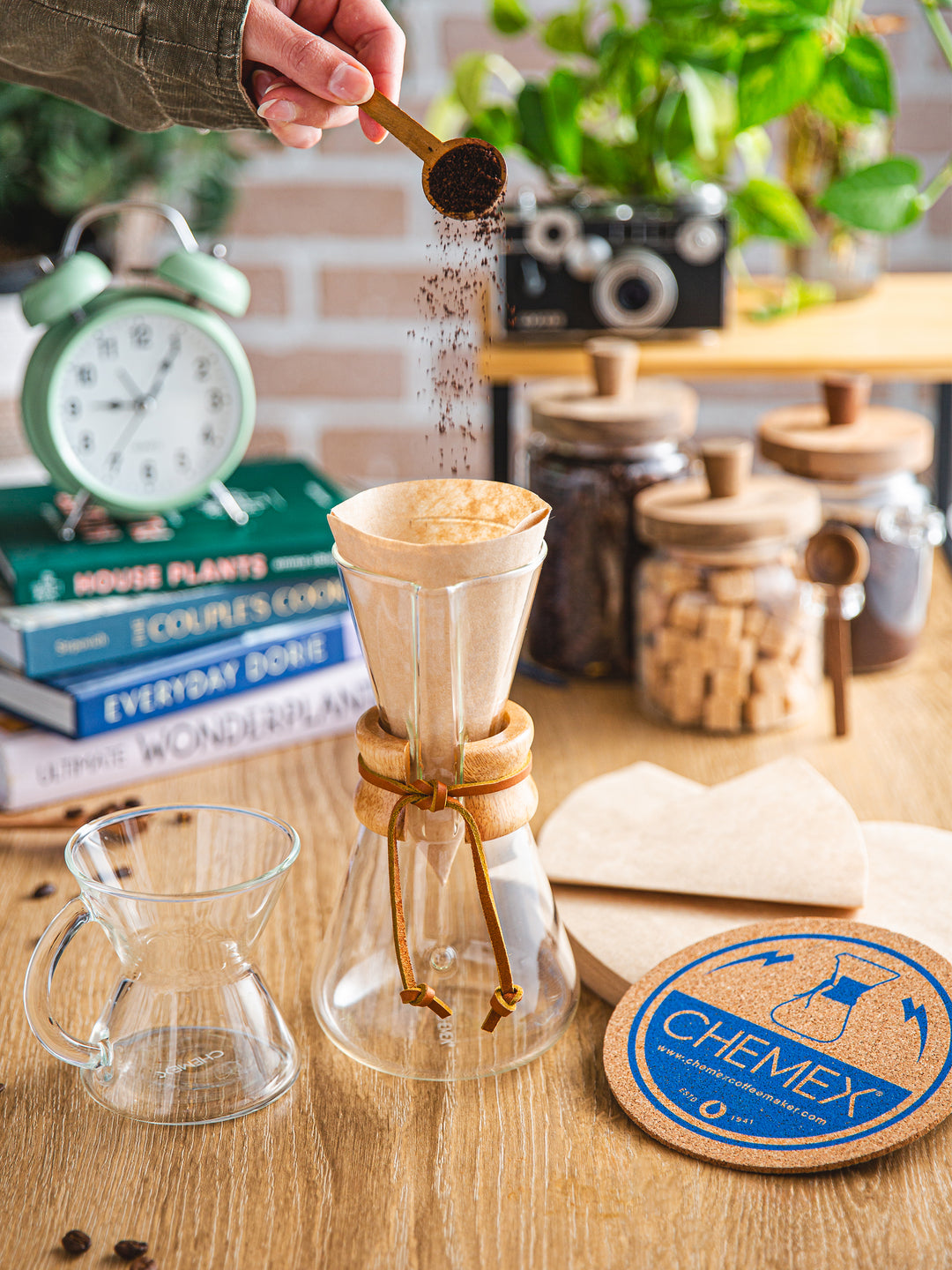 Urban Dweller set being used in a young persons apartment, surrounded by books, vintage camera, sugar and coffee bean containers.