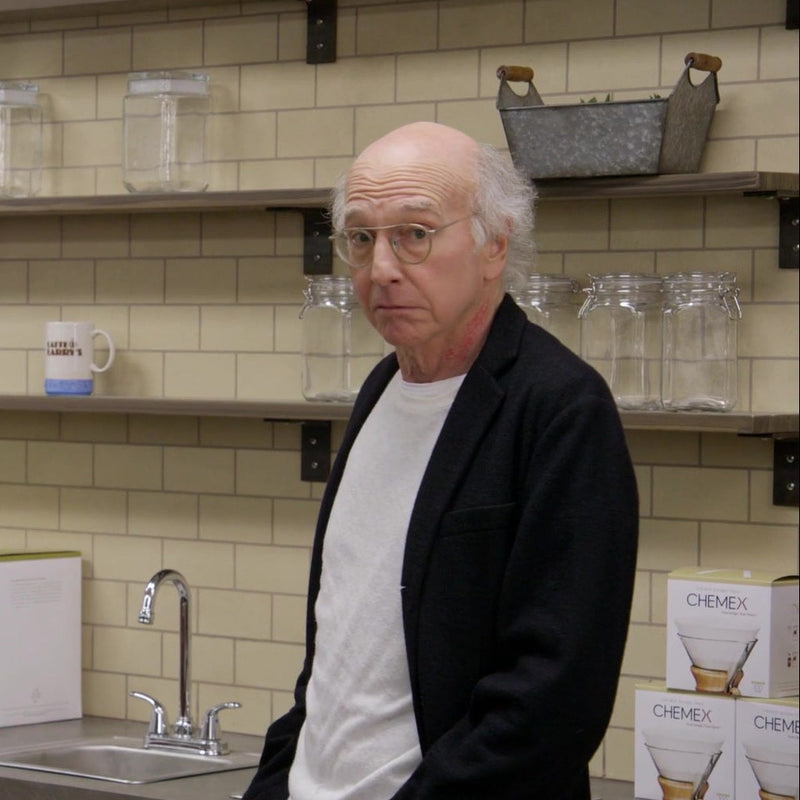 This image features a scene from Curb Your Enthusiasm with Larry David  and chemex filters in the cafe 