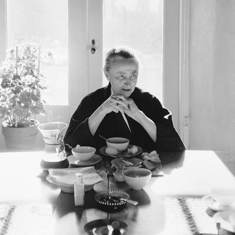 This photograph shows the artist Georgia O'Keeffe at her breakfast table.