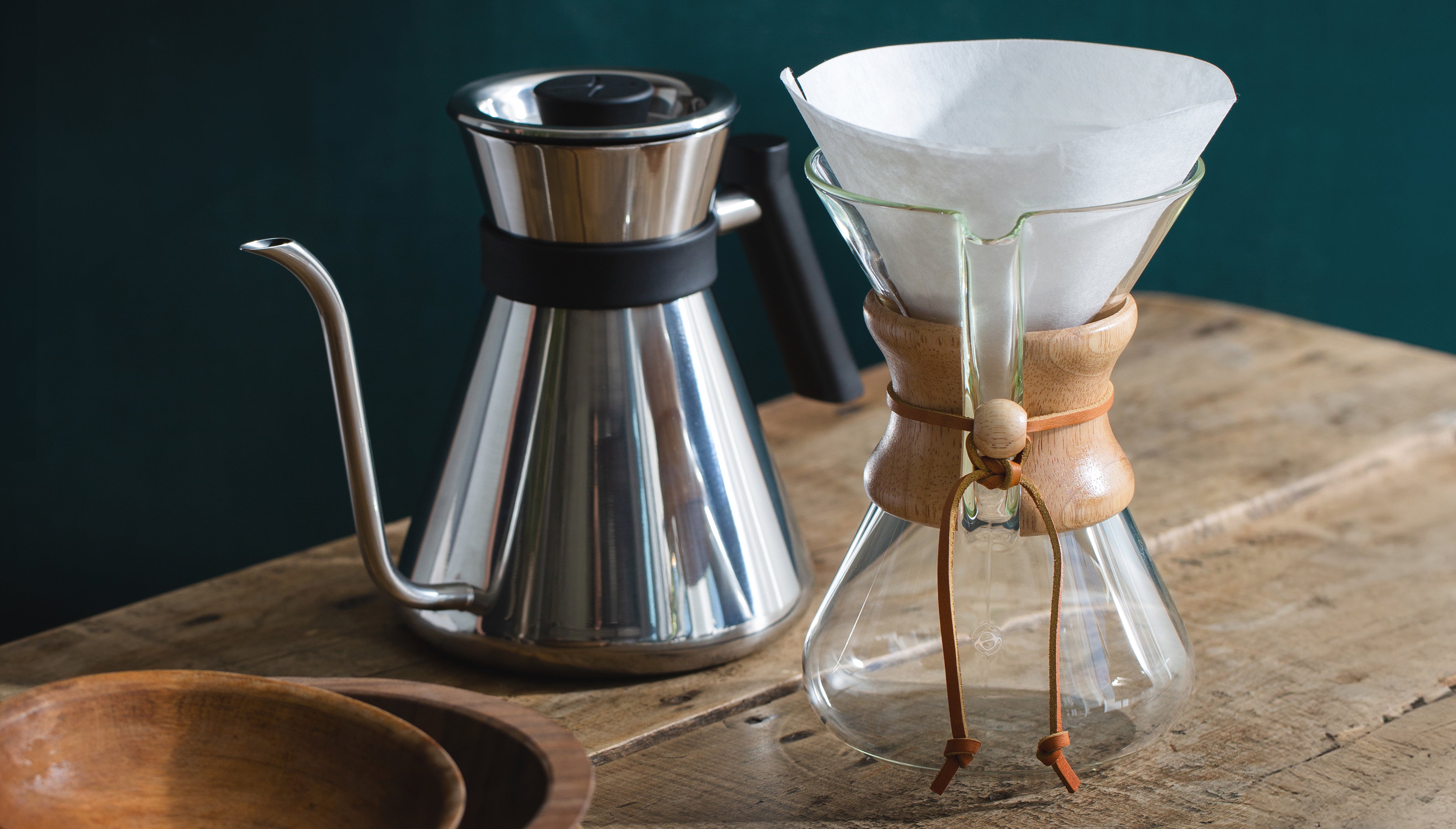 the chemex chettle on a table next to the handblown 5-cup coffeemaker