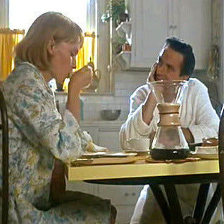 The iconic Chemex glass coffee maker, a staple of both 1960s kitchen design and Hollywood films, is featured on the table.