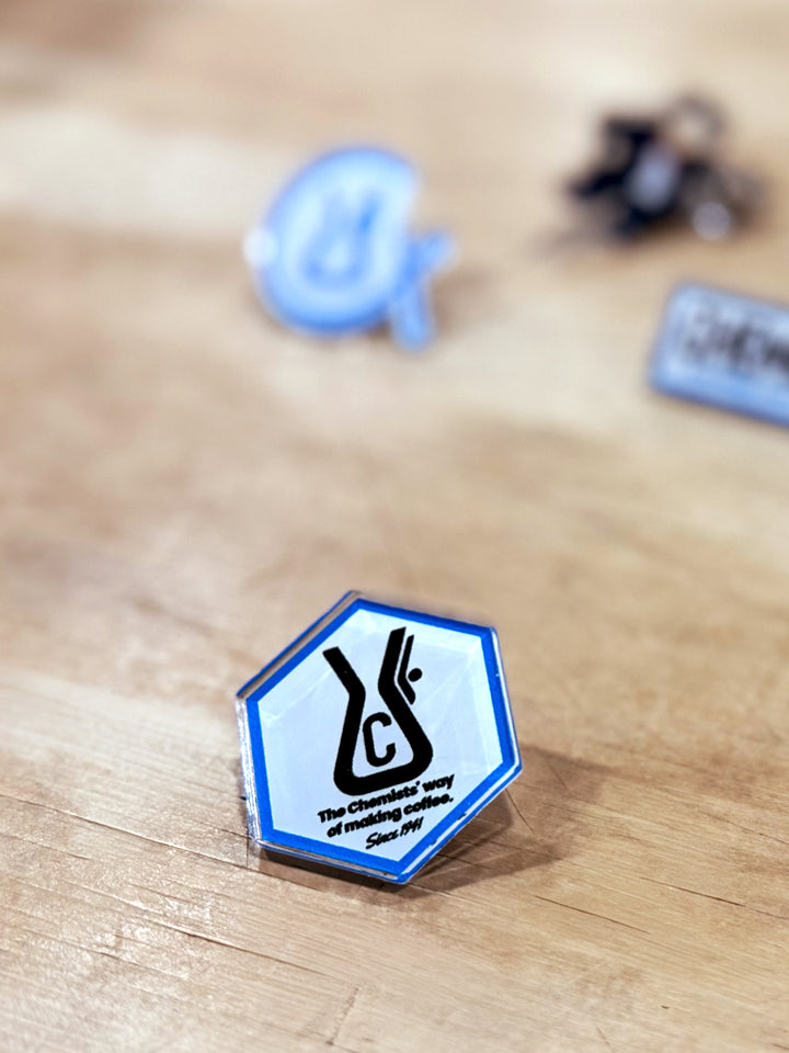 Chemex Chemist acrylic pin on a wooden surface 