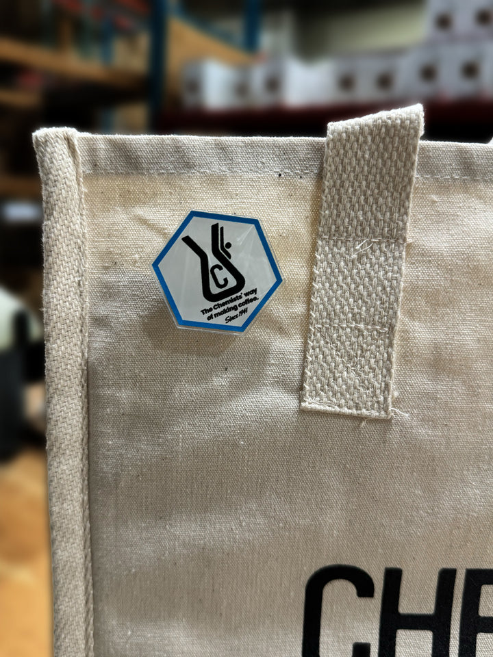 Chemex Chemist acrylic pin pinned on a tote bag 