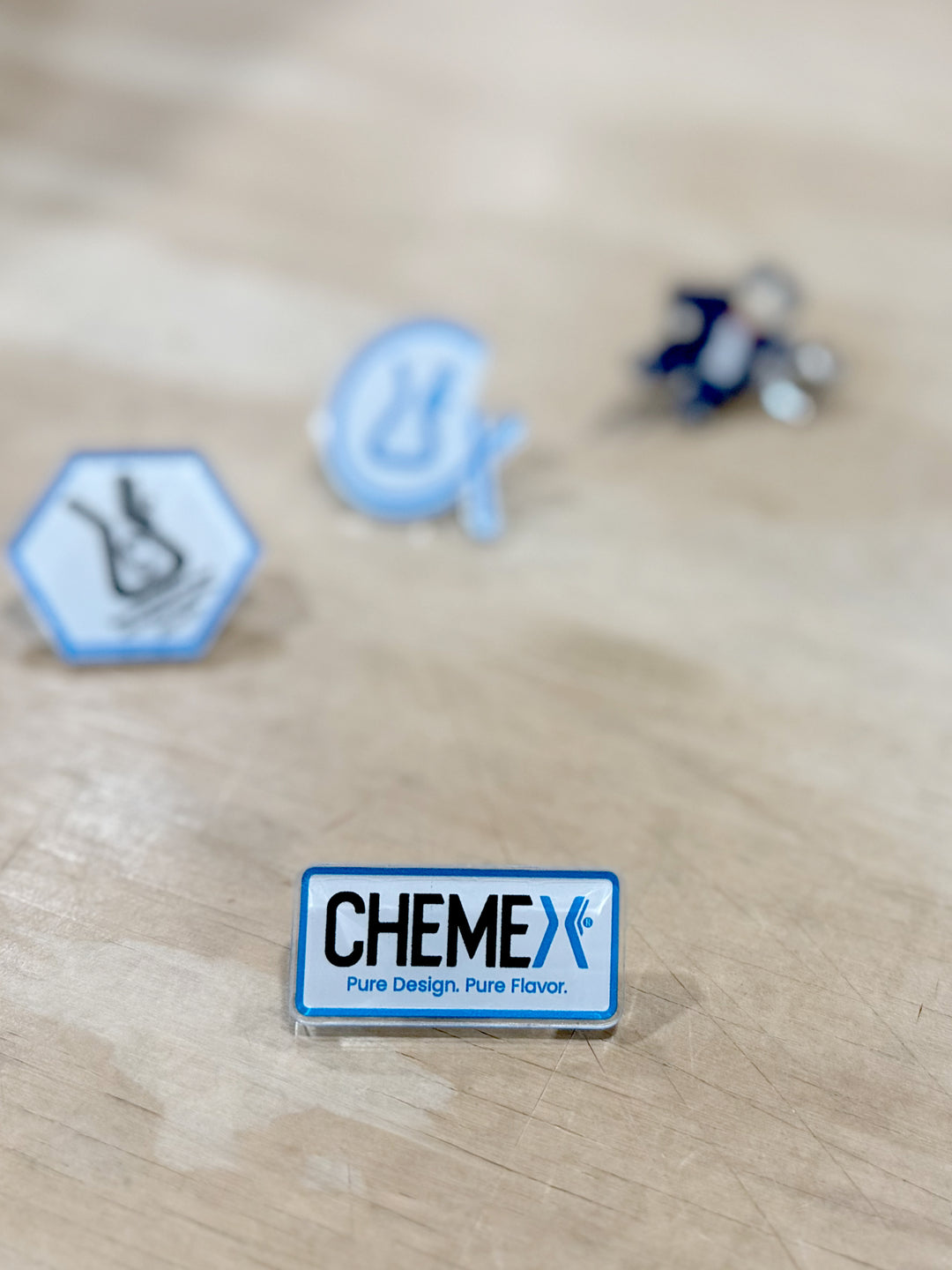 CHEMEX acrylic pin on a wooden surface