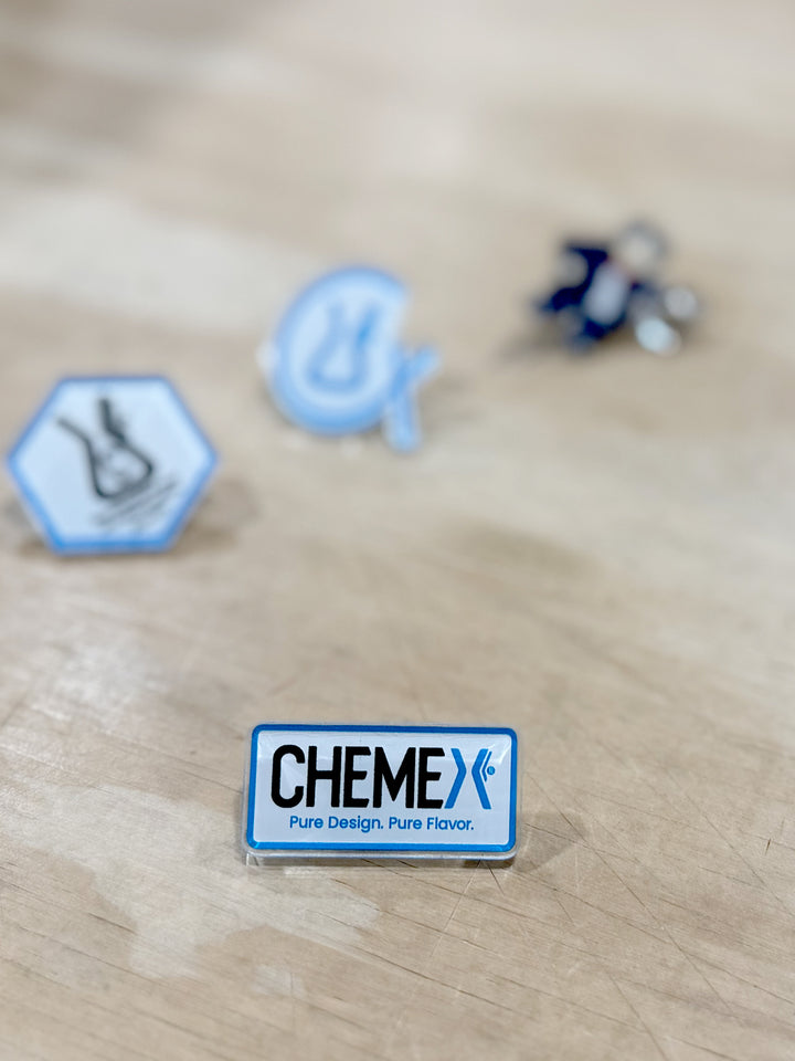 CHEMEX acrylic pin on a wooden surface