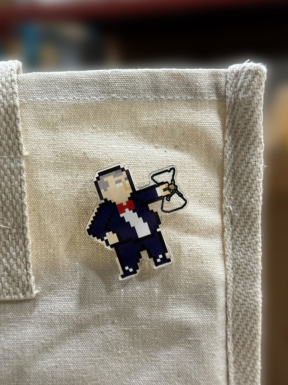 Dr. Schlumbohm acylic pin pinned on a tote bag