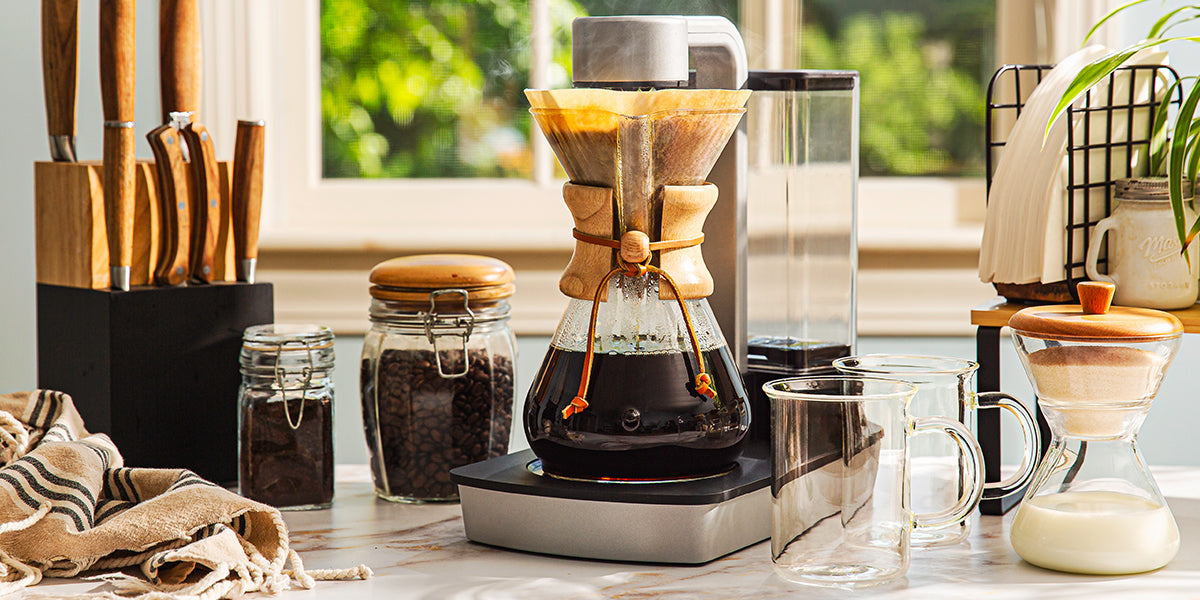 Coffee-making setup with a Chemex Ottomatic coffee maker on a kitchen counter.