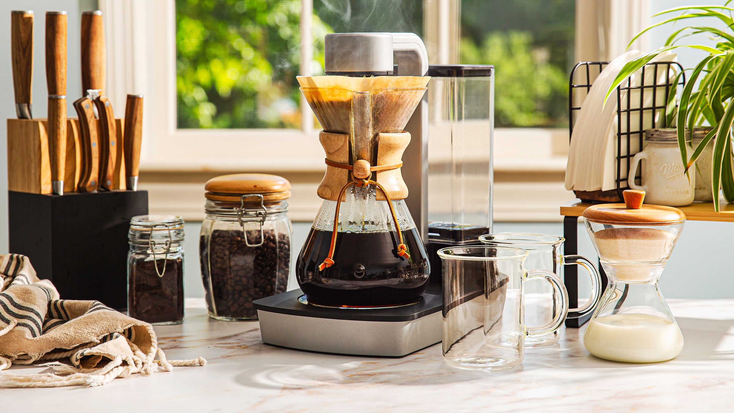 Coffee-making setup with a Chemex Ottomatic coffee maker on a kitchen counter.