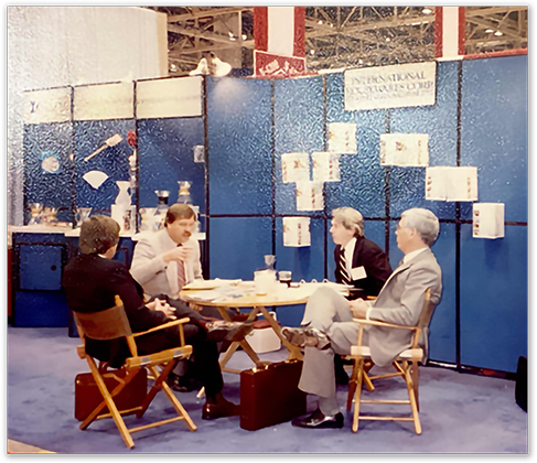 Chemex team at a small conference-room booth at a trade show, International Cookware Corp signage in background, 1990