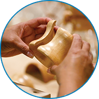 Hands fitting the rawhide collar on a Chemex coffeemaker, 2026